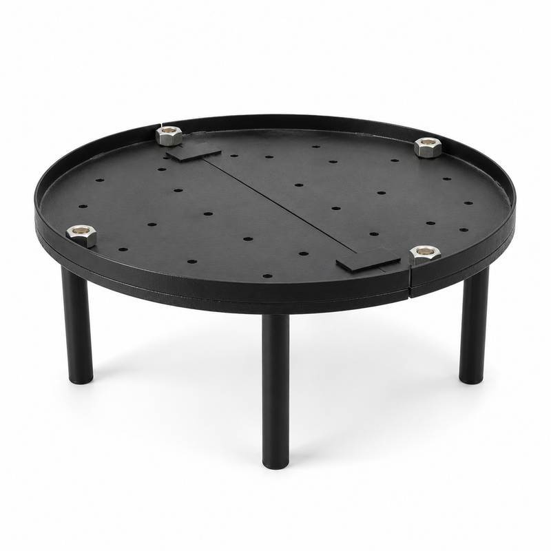 Tandoor Baffle Plate AS02 – fully assembled round black steel baffle plate on four legs, showing perforated surface with air-flow holes, centre divider bar, and four stainless steel hex bolt leg fasteners, angled three-quarter view on white background